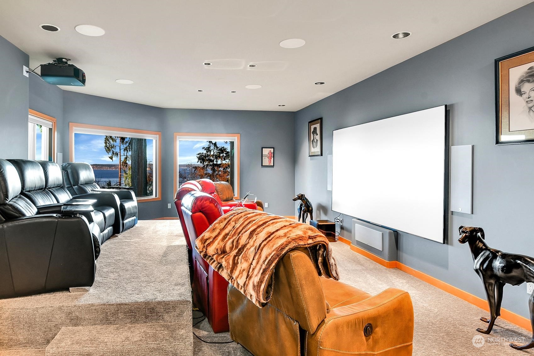 Huge projector screen, remote-controlled blackout shades, and luxurious high-end leather recliners for ultimate comfort.