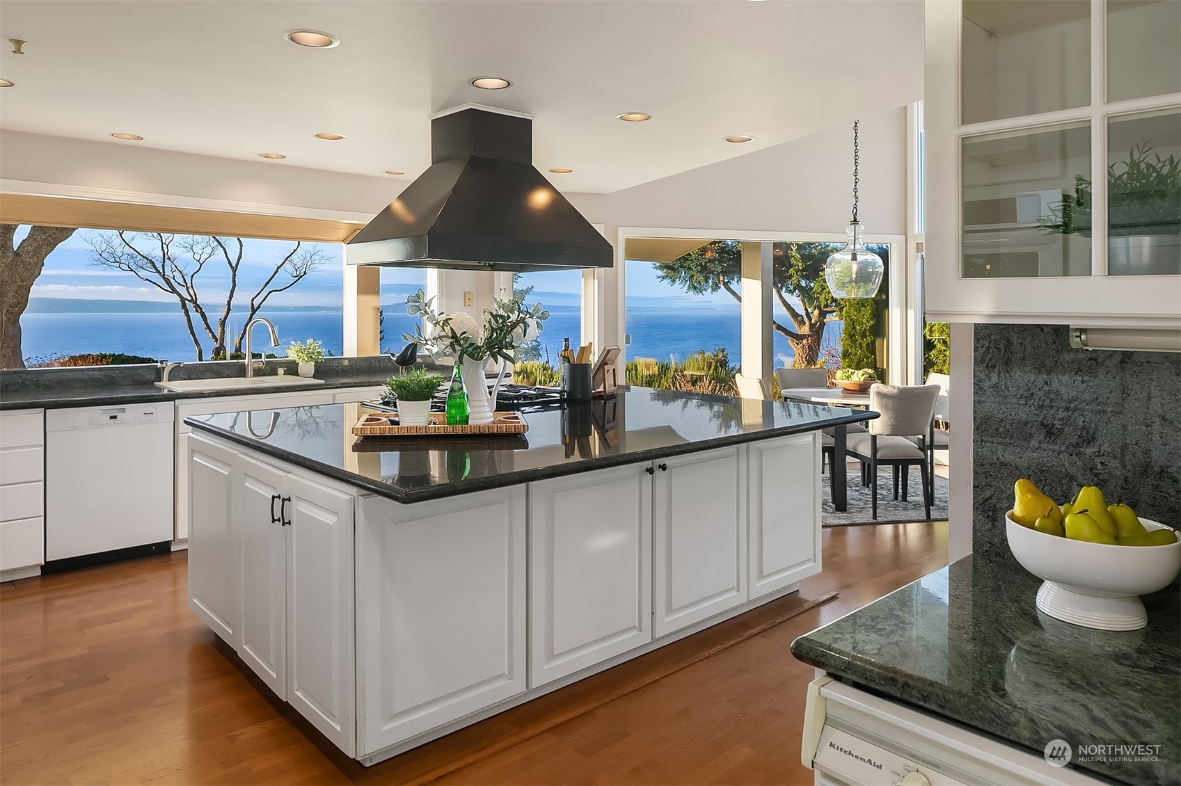 The kitchen is a delight! So much storage, work space and natural light as well as the beautiful setting! Chef's kitchen has a massive island, 6 burner gas cooktop, double ovens, 2 dishwashers and a walk in pantry!