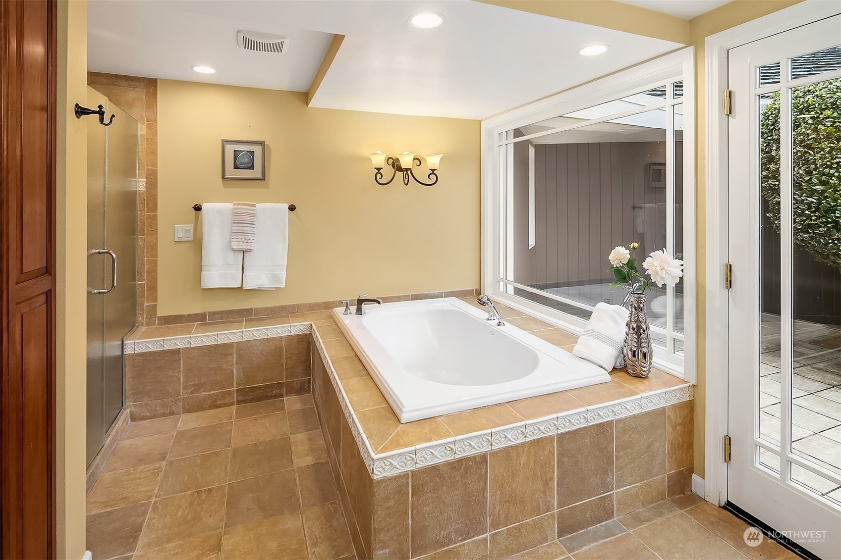 Spacious tub and separate shower with lots of natural light, all behind the fence in your private courtyard.