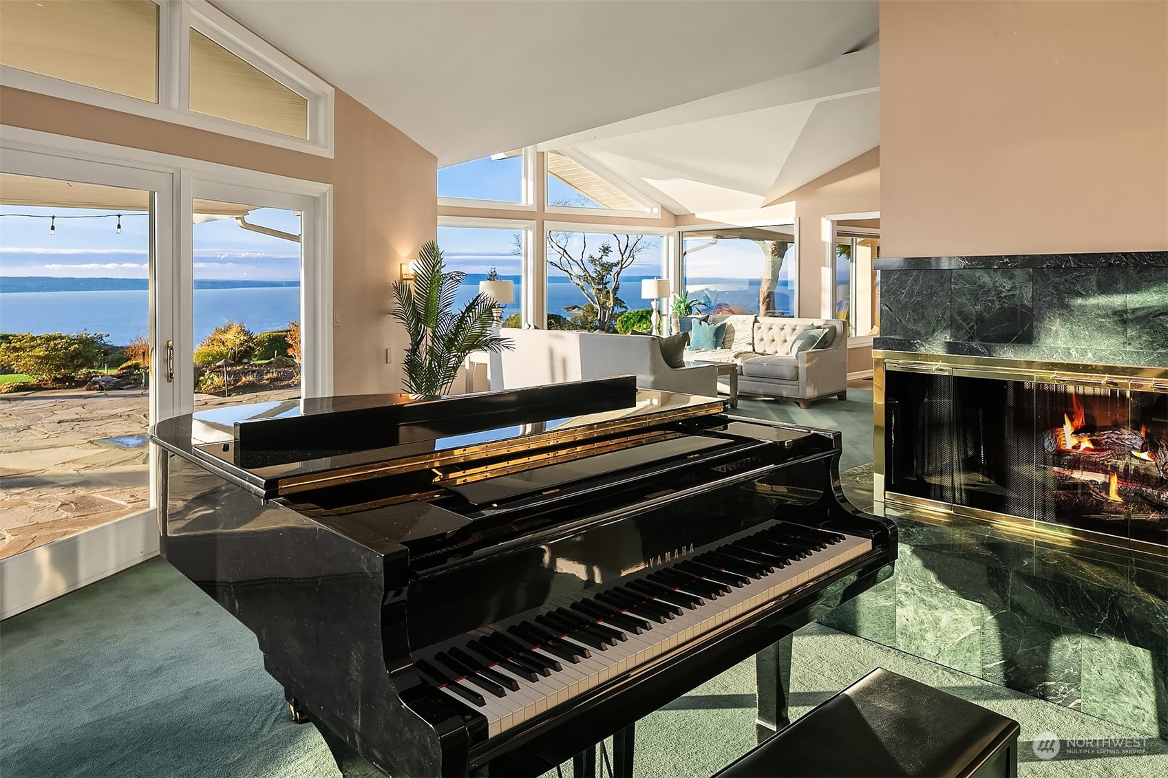 One the left of the living room and sharing the large wood burning fireplace is an ideal place for a piano!