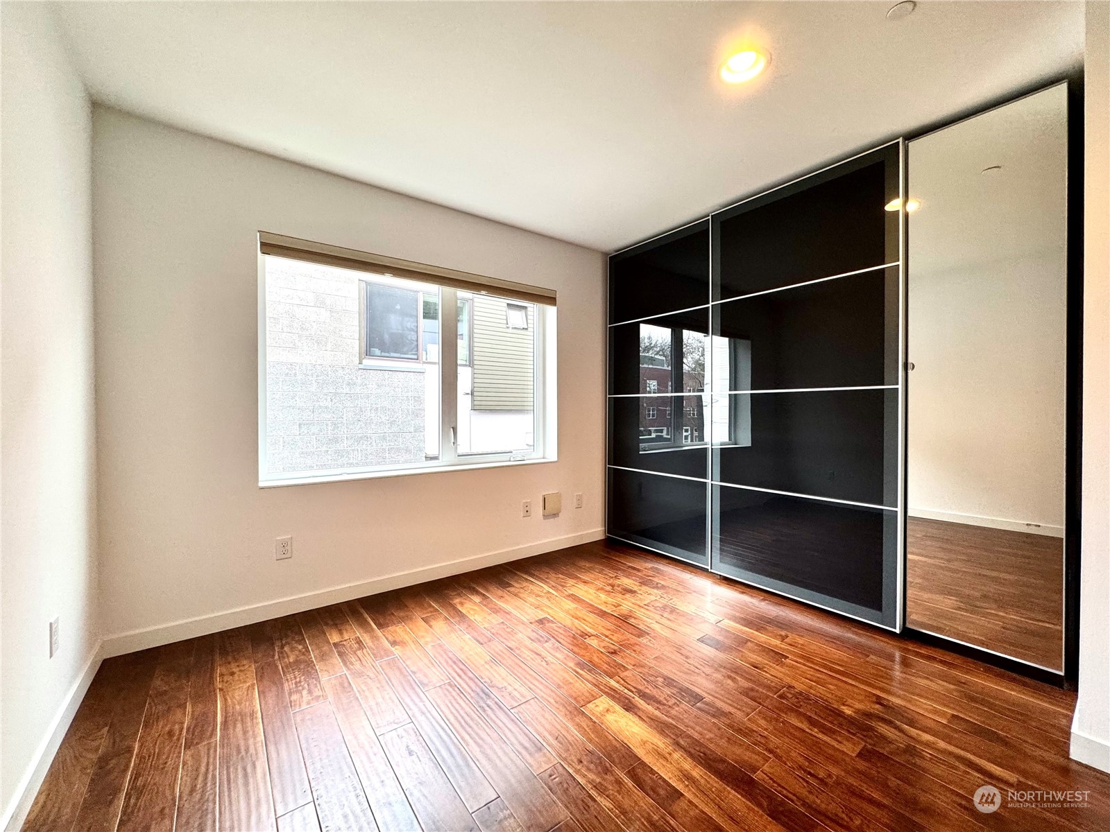 Beautiful sliding glass closet doors and mirror.