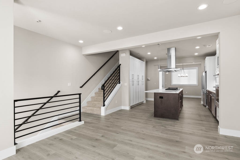 Hardwoods throughout the main floor and modern metal railings.