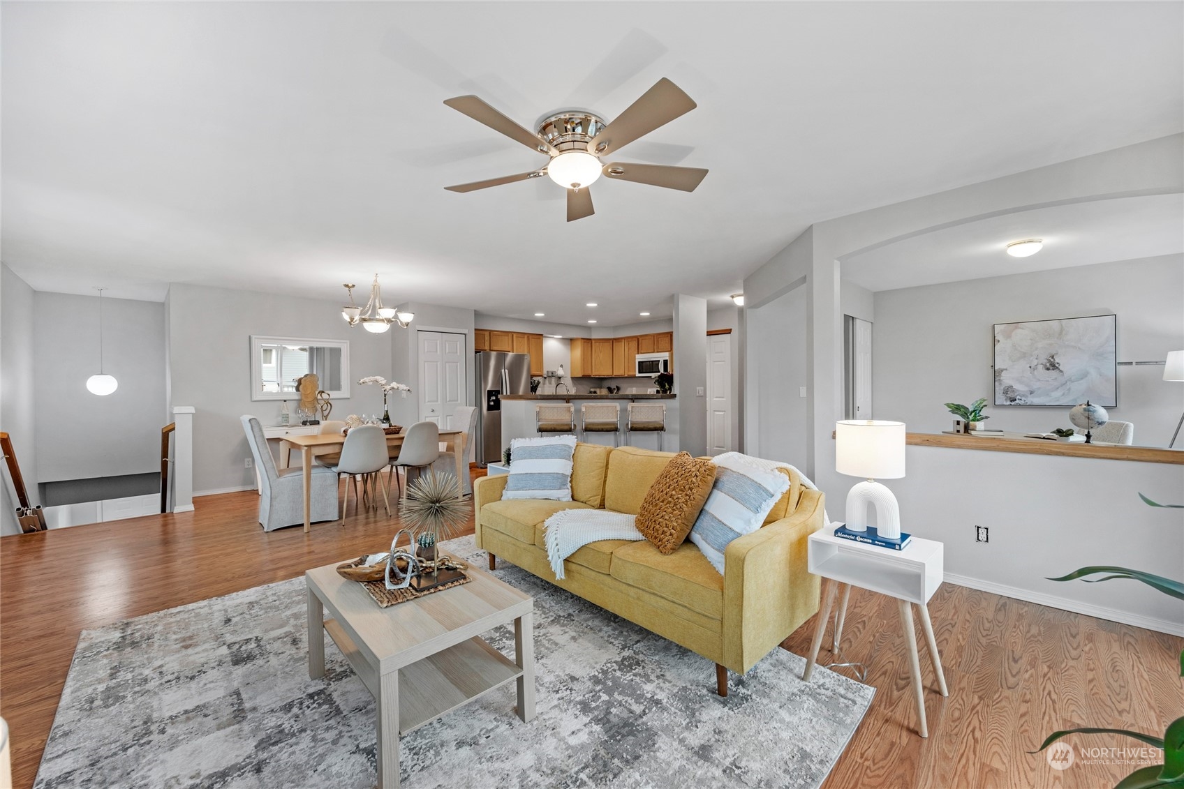 Living room area with a cozy gas fireplace and built in entertainment and display niche. The large window looks west and the whole area gets lots of good natural light. Ceiling fan and light.