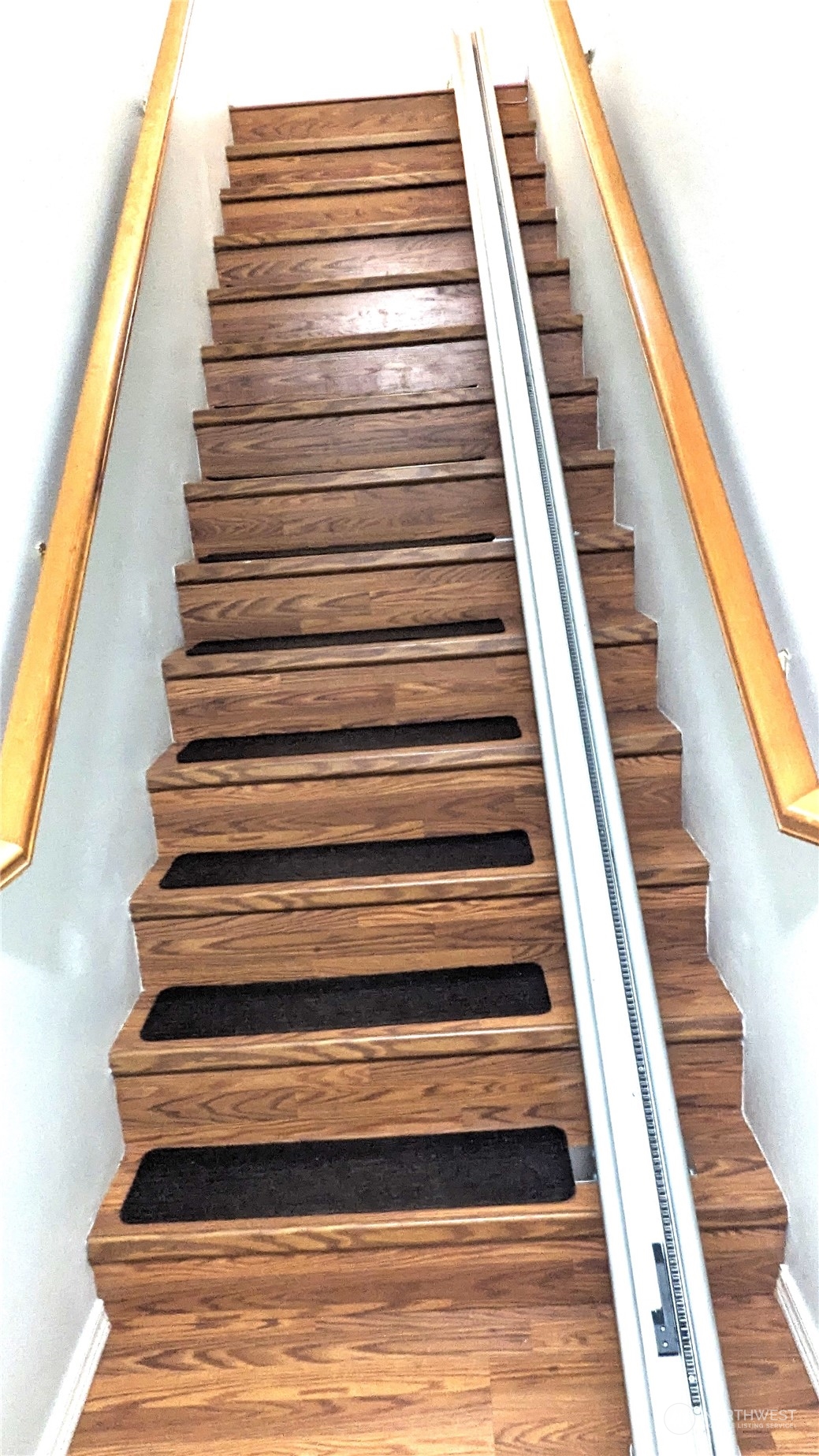 Stairway down to your main entry and garage. Where the white table is now was a large China Cabinet so plenty of room to stash your finer dining items.