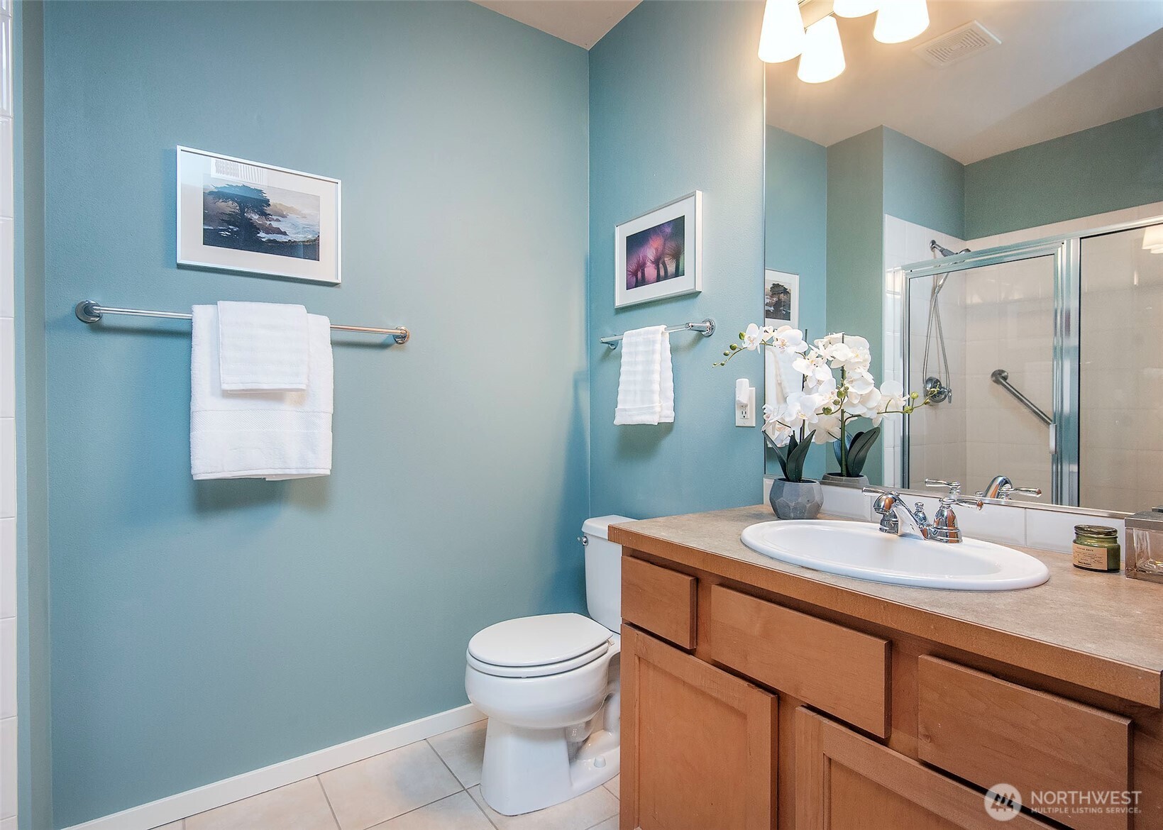 Guest bath with tons of storage and glass shower door