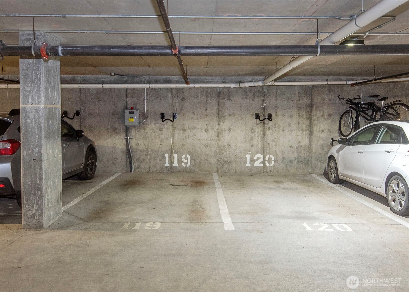 Designated parking spot 119 and bike rack. Storage unit located on same floor as parking p3