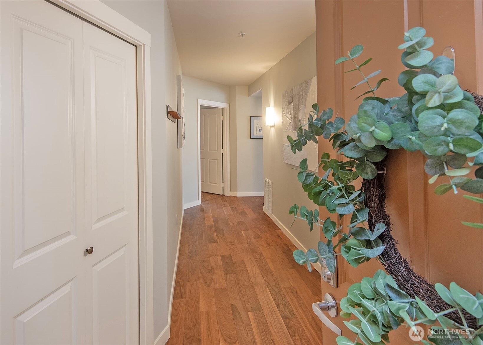 Front door leading to spacious hallway and front closet