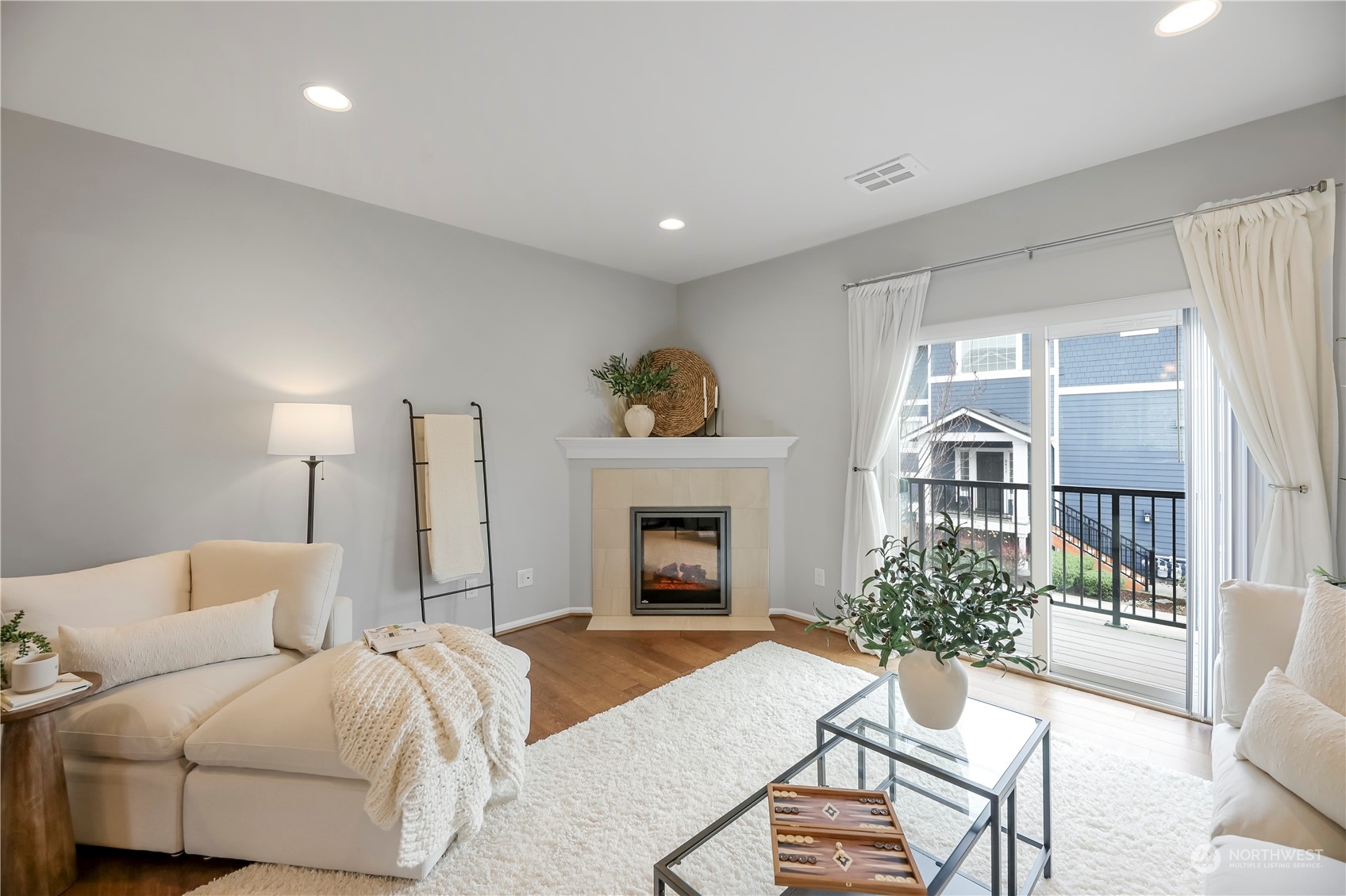 Living room with custom paint and electric fireplace that can provide ambiance year round as heat is optional