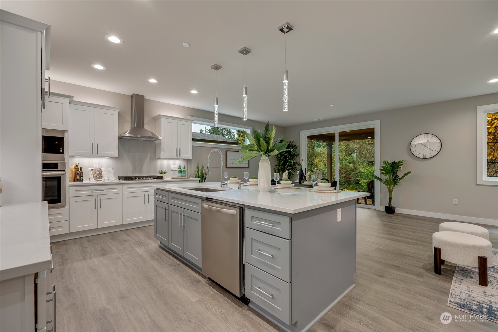 The heart of the home is the modern chef’s kitchen, featuring gleaming quartz countertops, top-of-the-line stainless steel appliances, and an abundance of cabinet space for all your culinary needs.