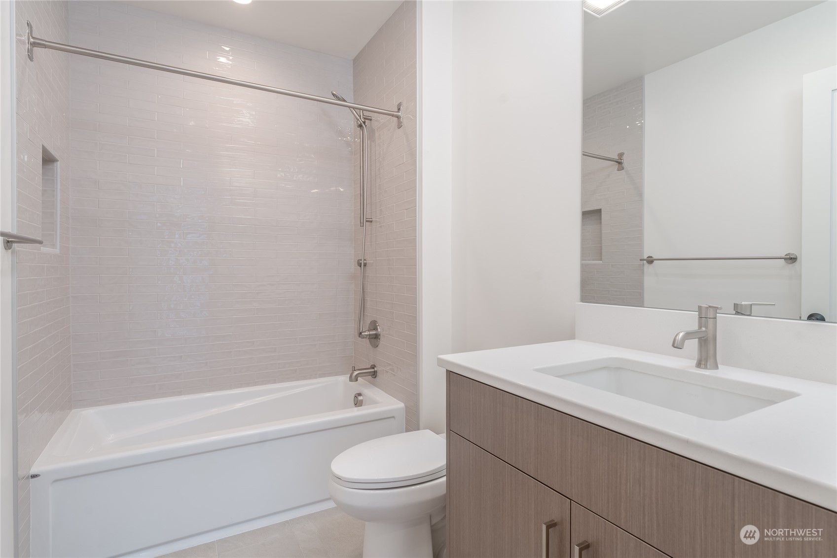 Main floor primary bathroom with walk in shower and heated floors