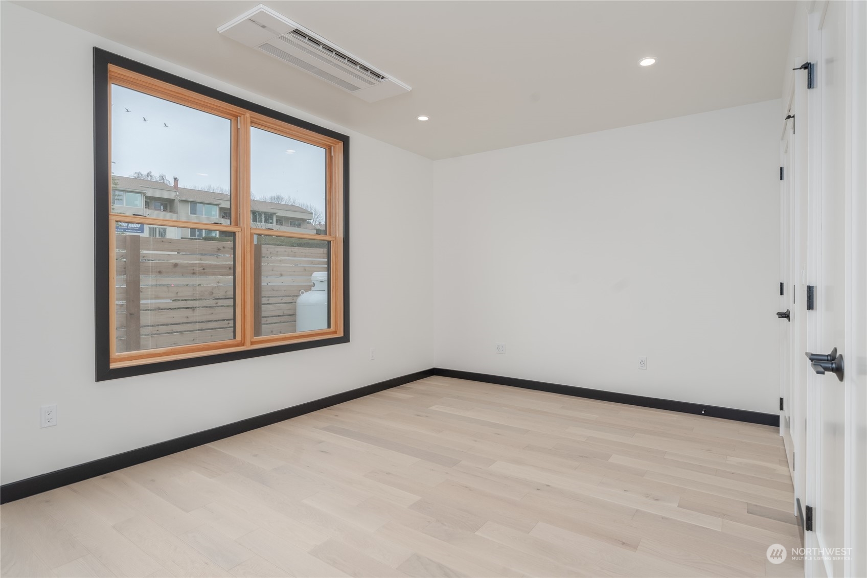 Upstairs primary bedroom with balcony