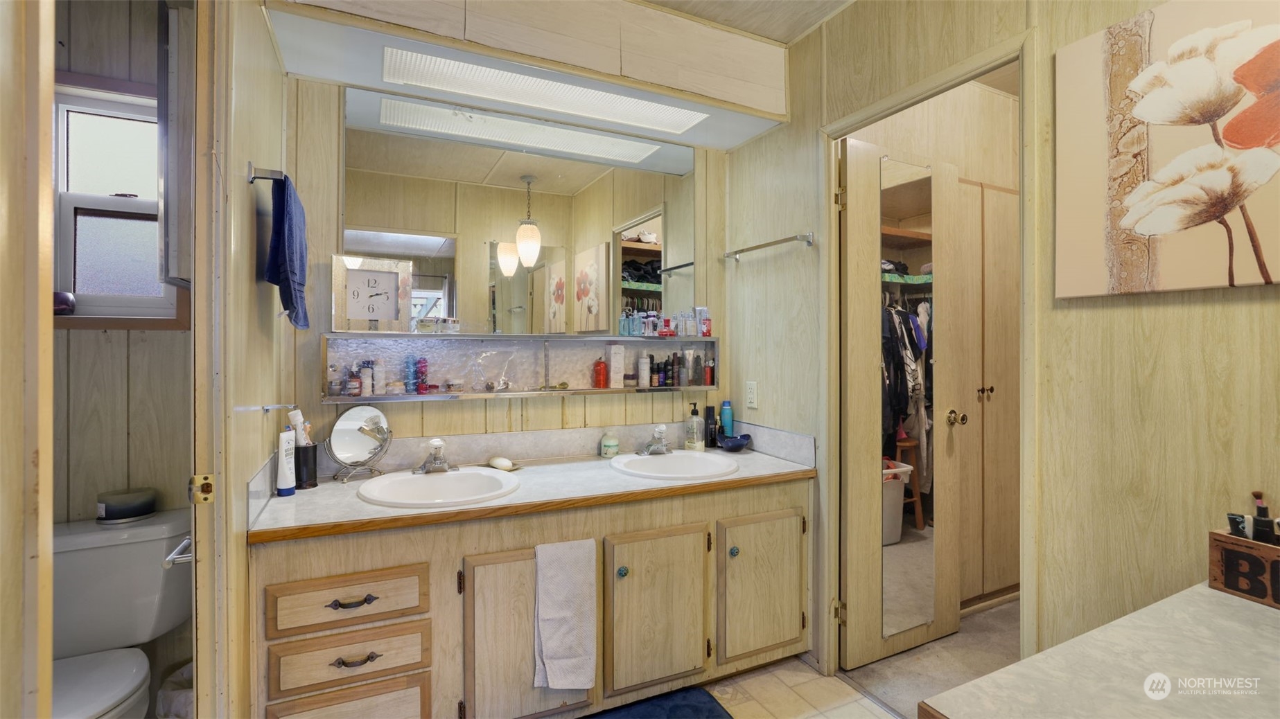 Primary bathroom with dual sinks and separate water closet.