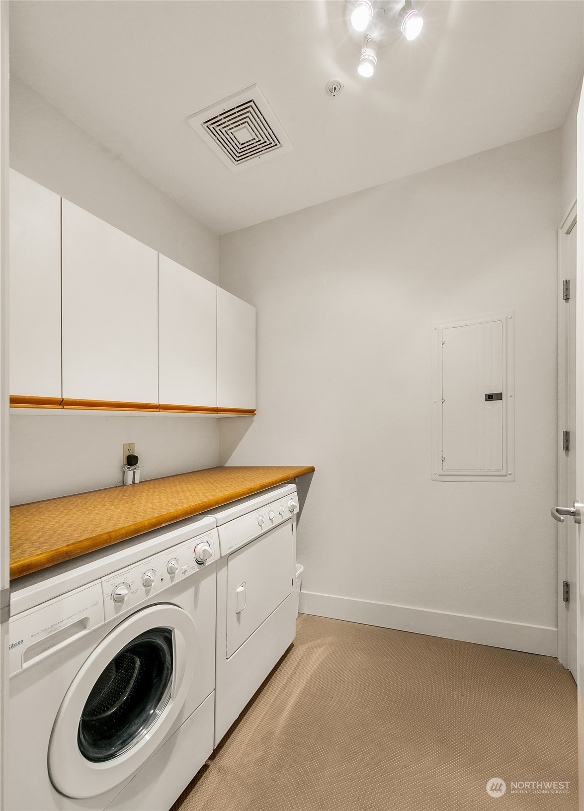 Laundry room has a generous folding table, dryer is gas and plenty of storage behind the door and in the cabinets.