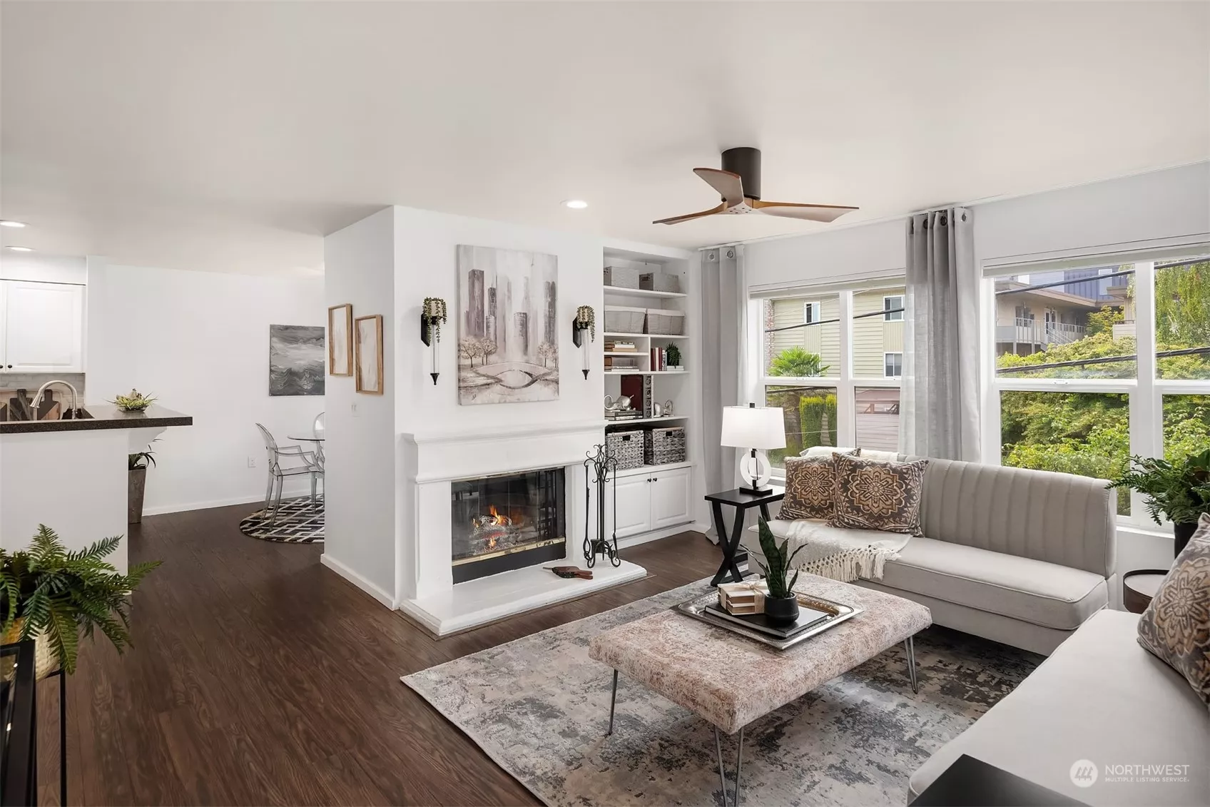 West facing windows, an open floorplan, and a cozy wood fireplace