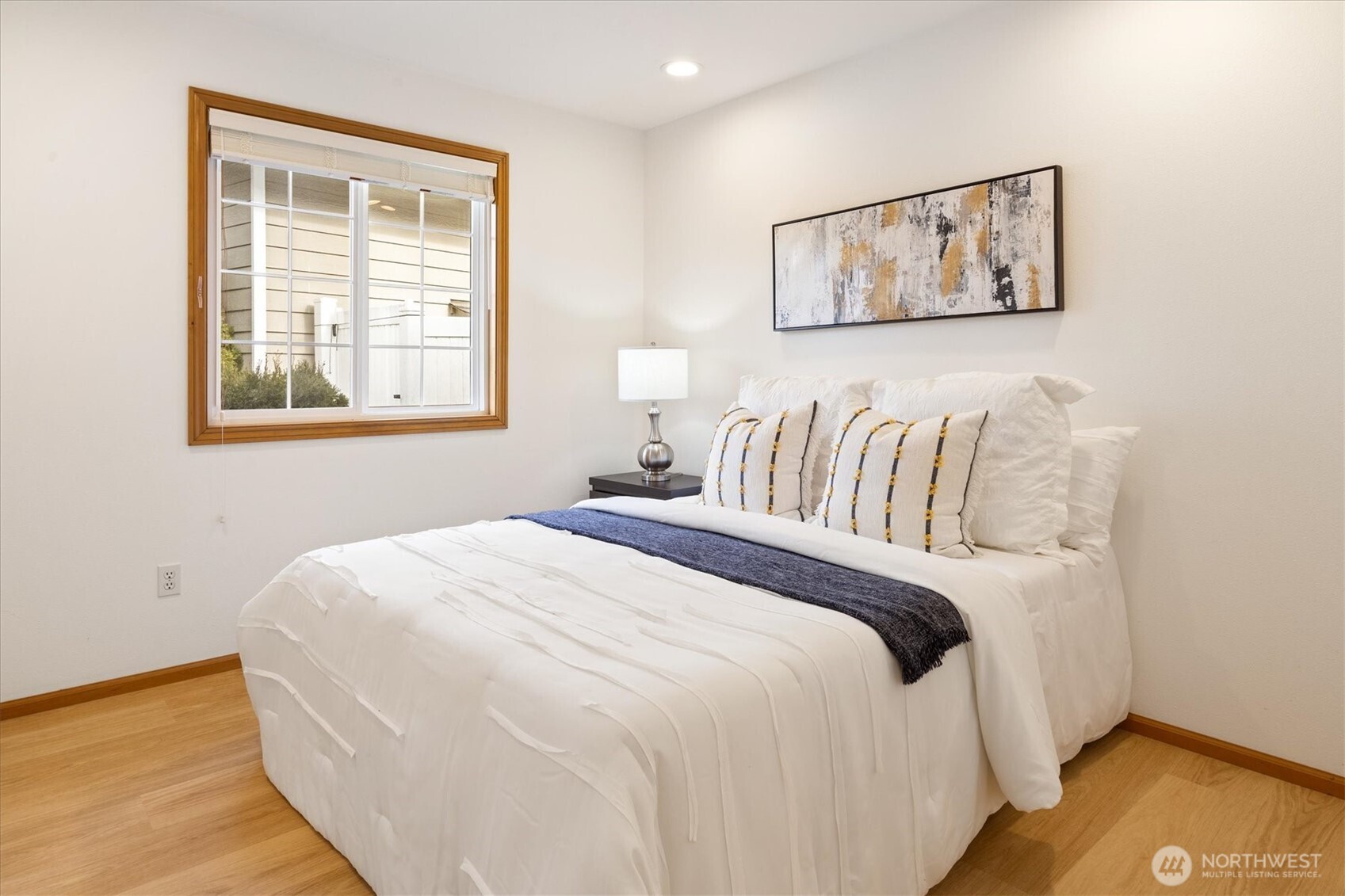 Bedroom 2: A light and bright, spacious room equipped with custom closet organizers and window coverings.