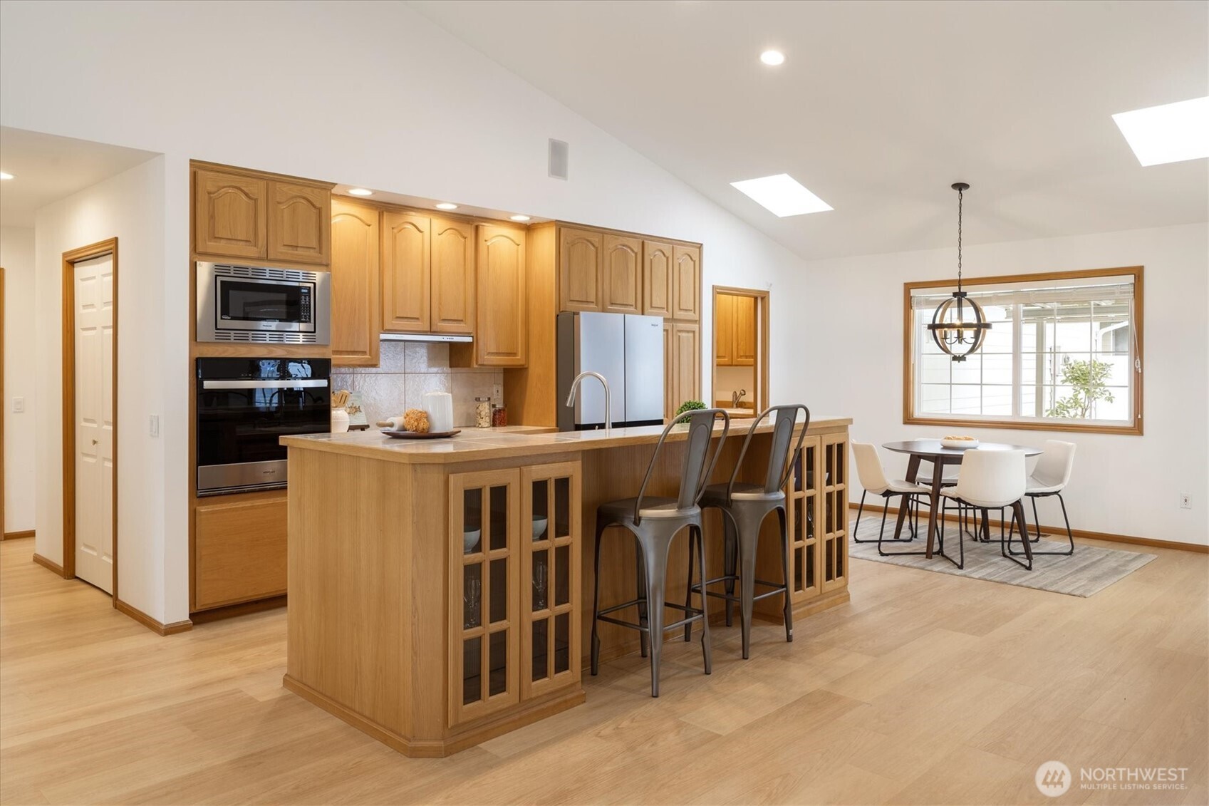 Gather around the inviting center island with a raised bar, where sleek stainless steel appliances and a gas cooktop make every meal preparation a joy.