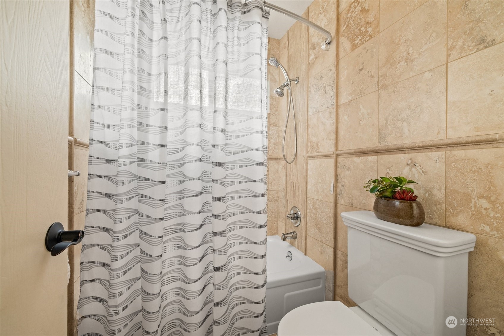 Tub/shower with heated travertine floors.