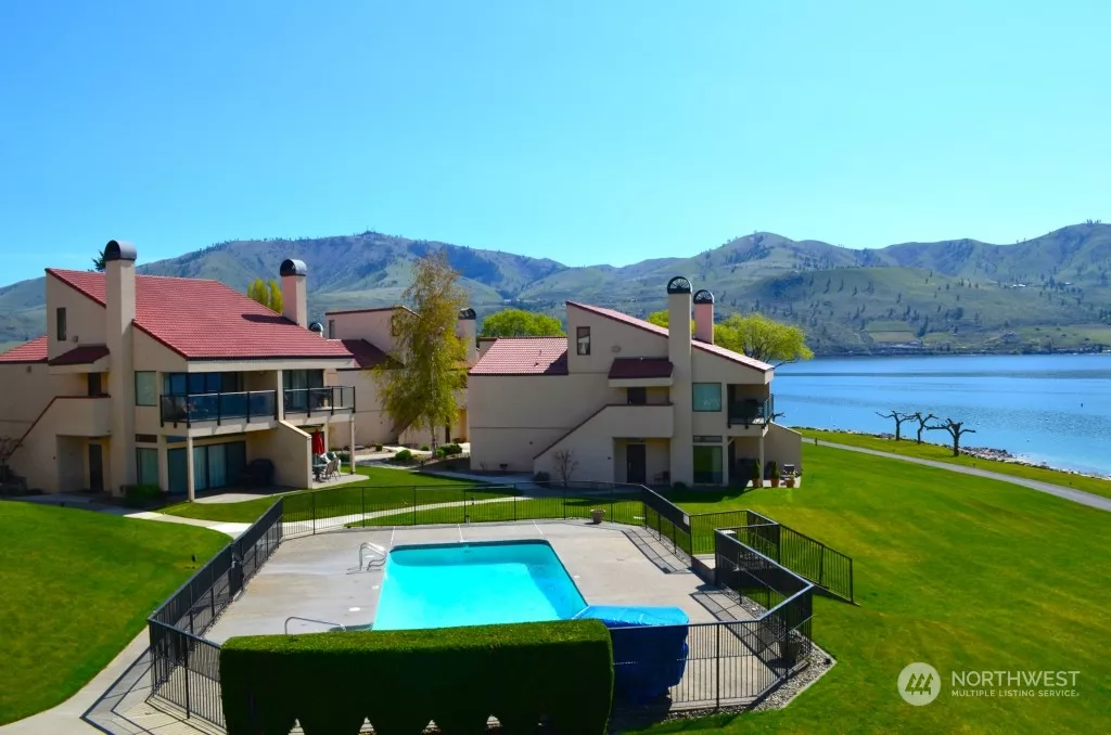 Condo overlooks 1 of 5 swimming pools.