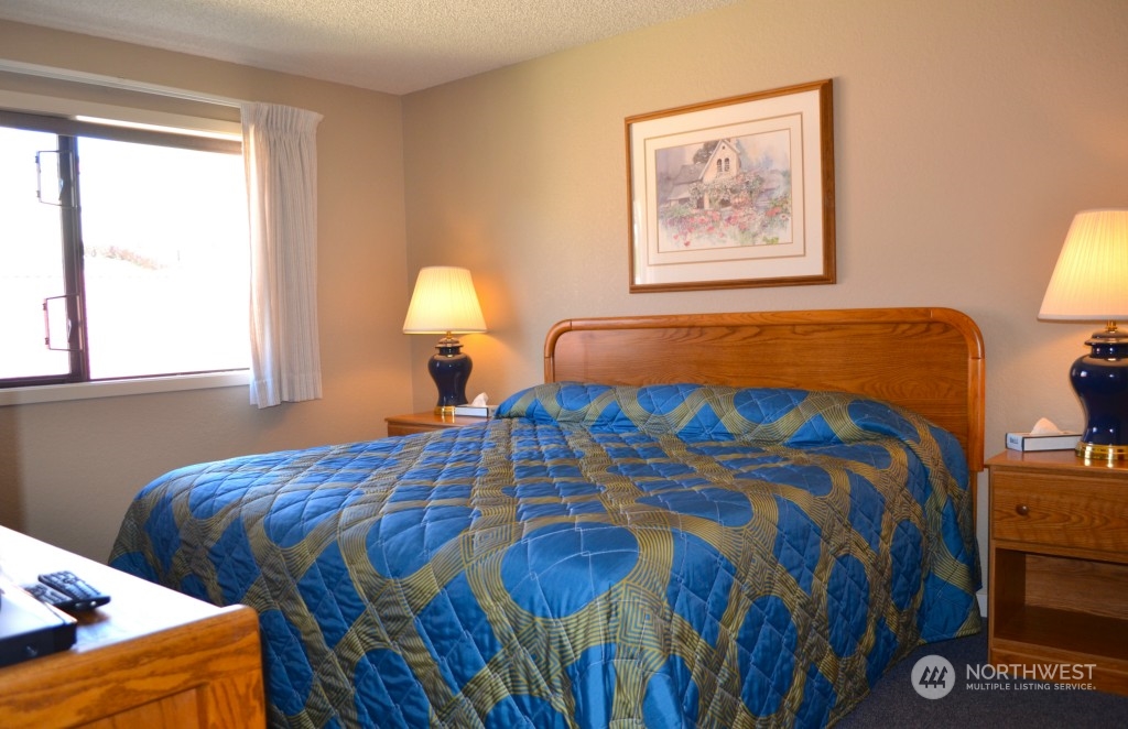 Master bedroom with king bed and sitting area.