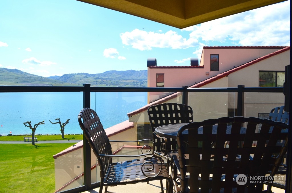 Enjoy the view from the spacious balcony with outdoor dining space.