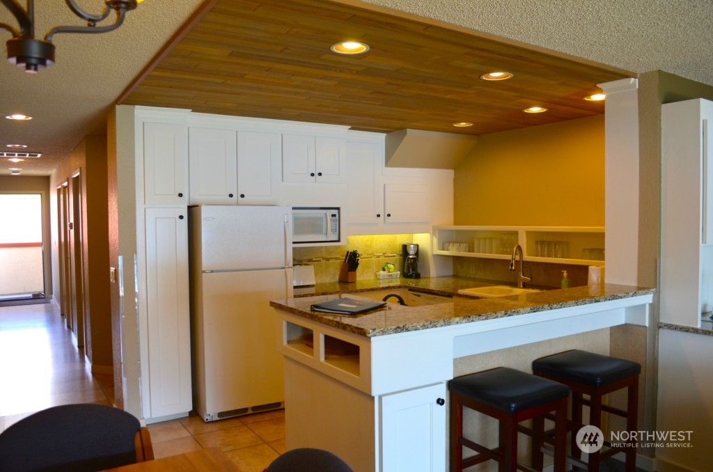 Great open kitchen with eating bar and slab granite counters.