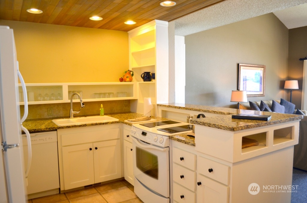 Updated in 2012/2013 with painted white/cream cabinetry and slab granite countertops.