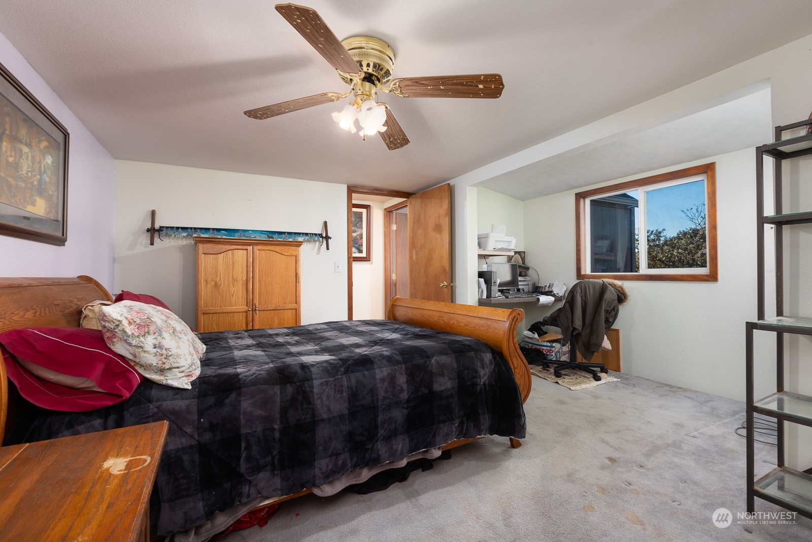 The primary bedroom features an alcove with a built in desk area.