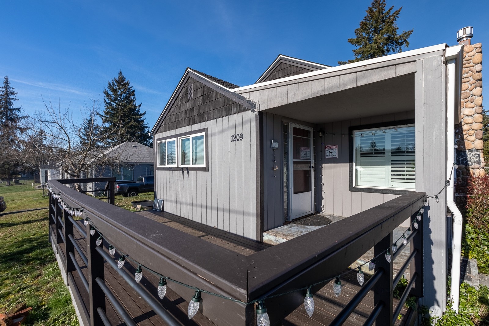 Covered porch to keep you out of the rain and keep the house cooler in the summer.