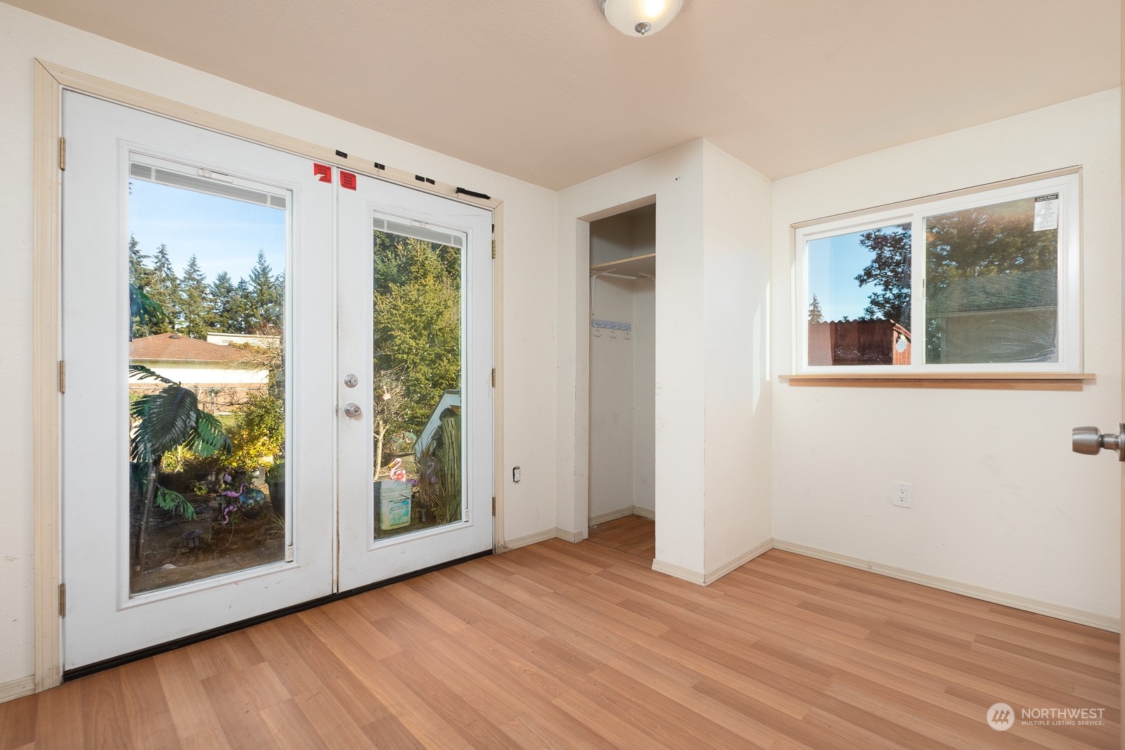 The updated third bedroom features a closet and has French doors to the back yard.