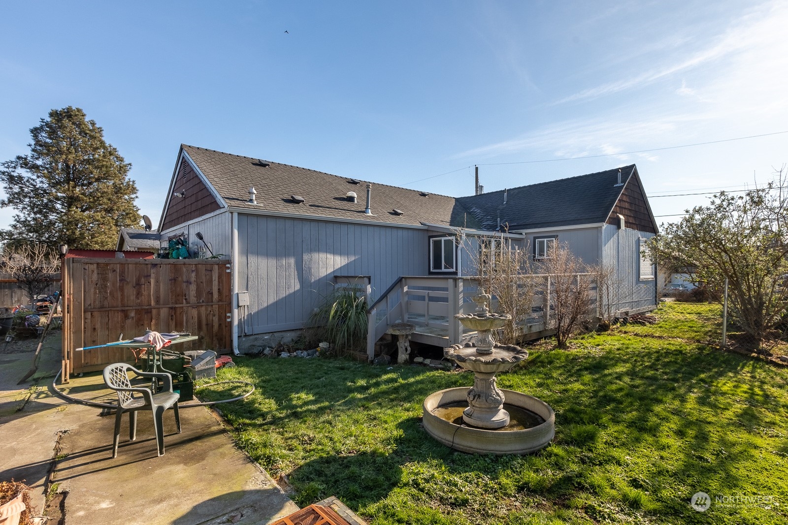 There is a large cement slab that covers much of the back yard.