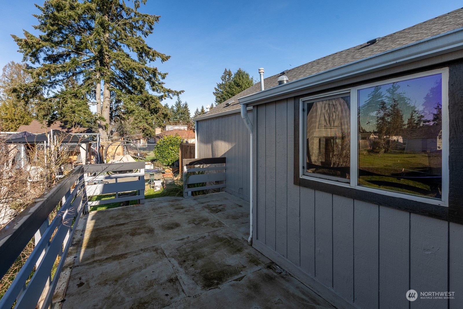 Looking at the west side of the house from the back, you can see an additional deck. This is located outside of the primary bedroom, so you could perhaps open up the wall and put a doorway there.