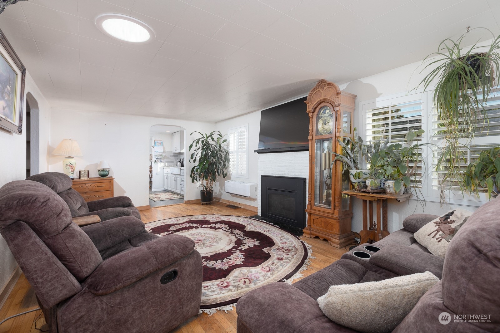 The gas insert in the fireplace is a lovely feature to keep you nice and cozy. Note the solar tube in the ceiling and the light it allows in. Arched doorways are a nice architectural detail. A mini split has been installed as well.