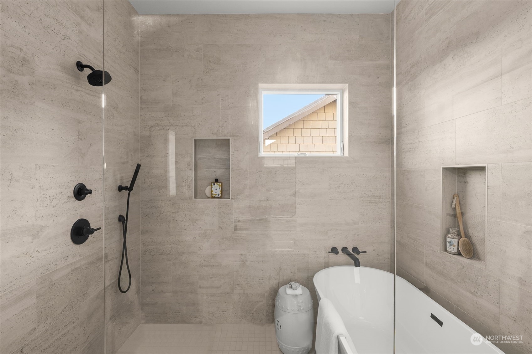 The elevated primary bathroom features a standalone tub, built-in shelving and dual-nozzle spray for your convenience.