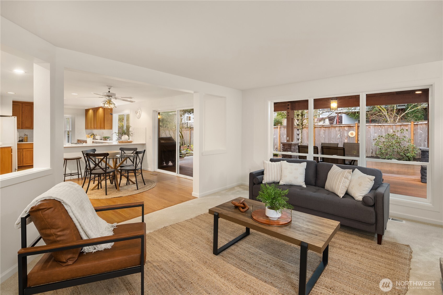 Large windows frame the backyard