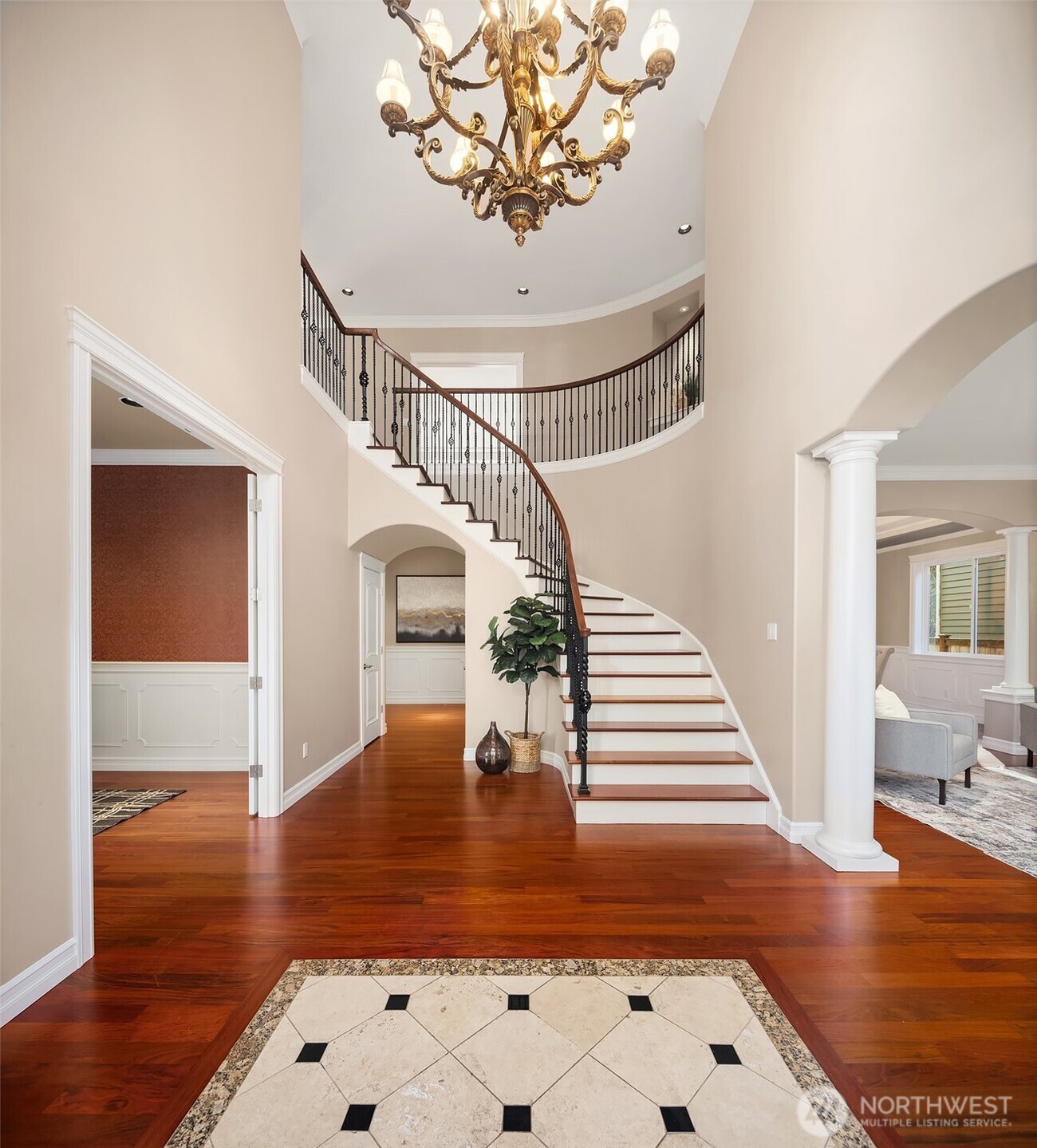 Stunning refinished Brazilian cherry hardwoods with tile inlay and sweeping wrought iron staircase.