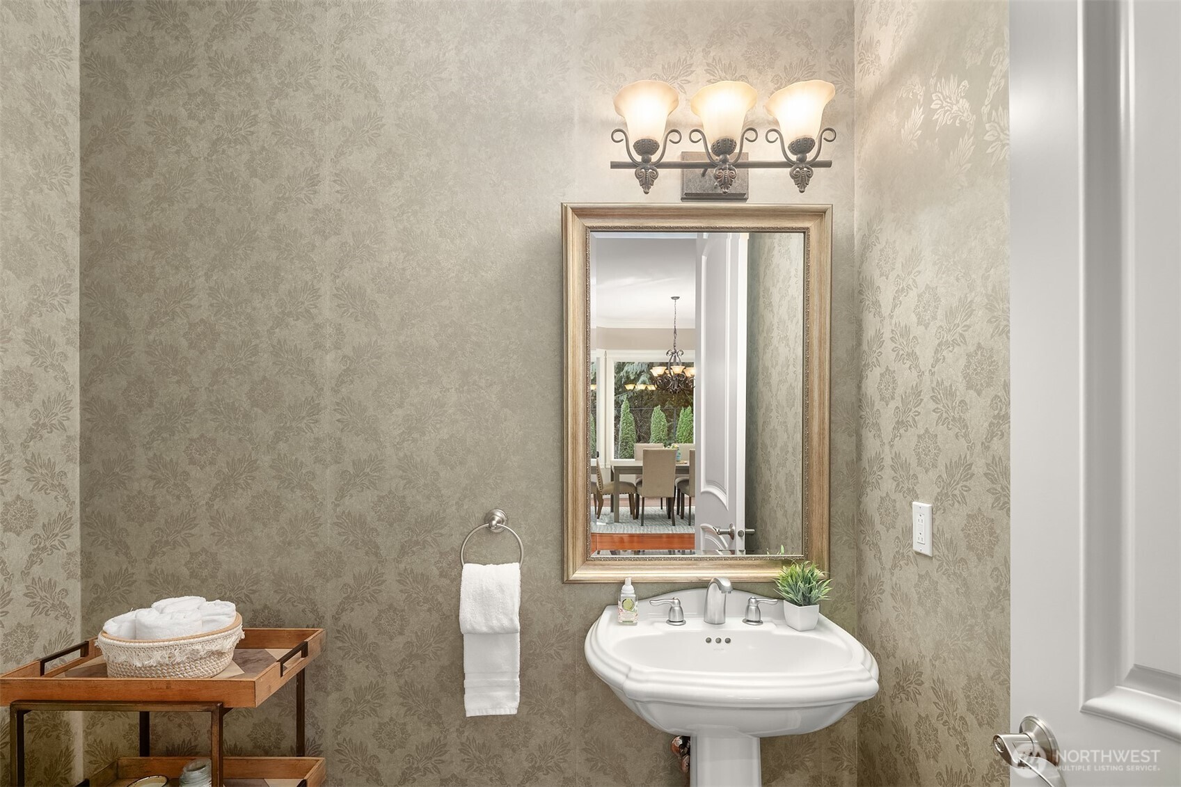 Main floor powder room with stunning wallpaper