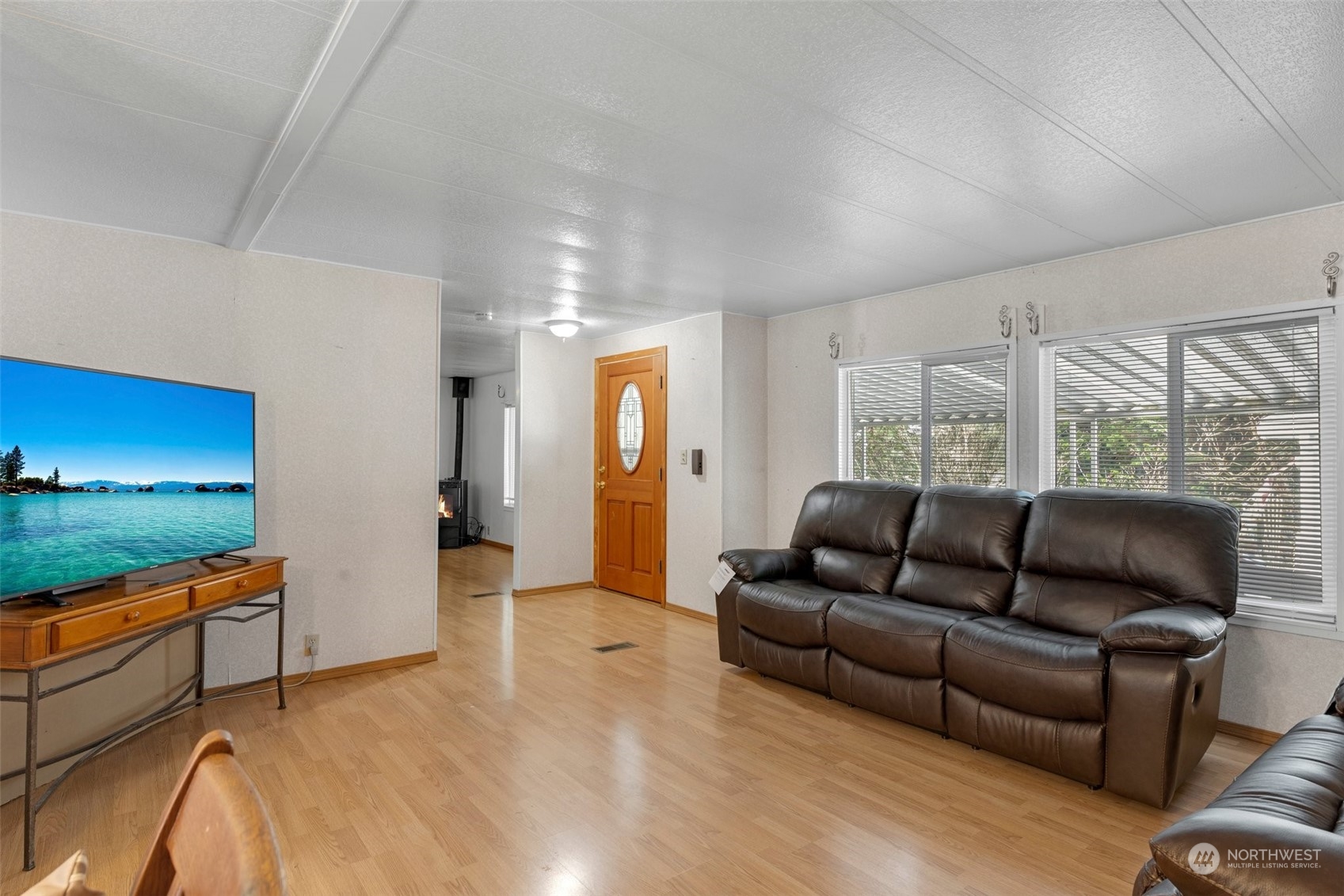 Main living room, front entrance and opening to bonus living area