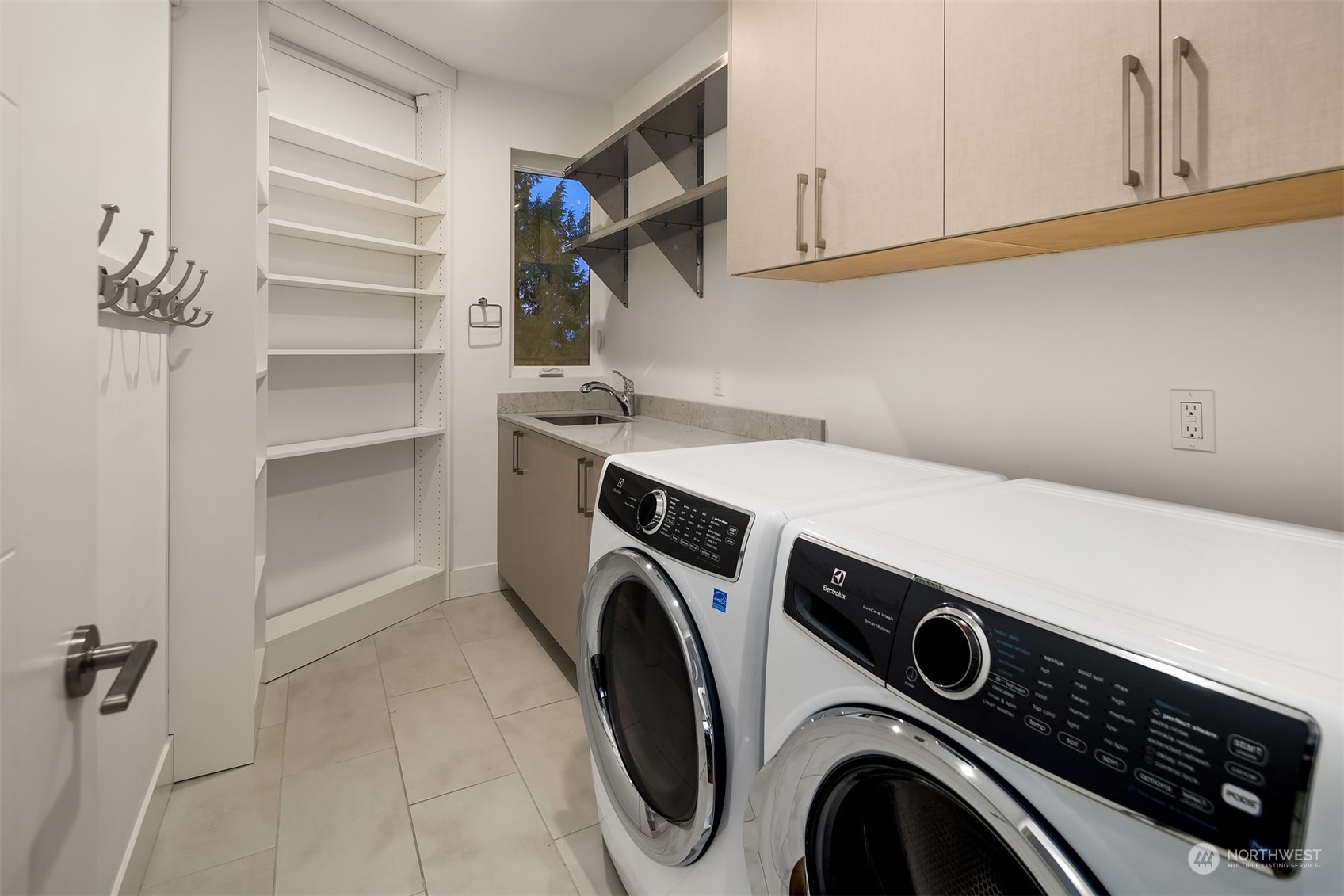 Laundry located on the top floor with ample storage plus sink.