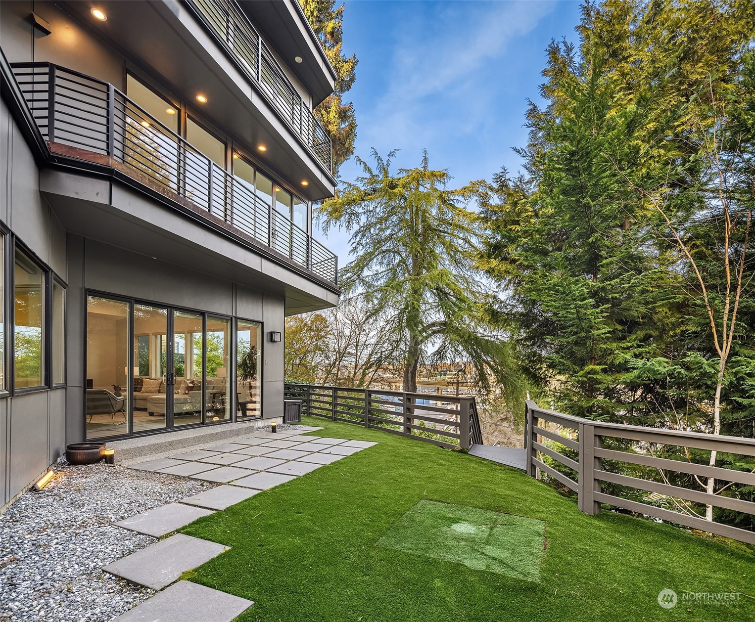 Turfed, spacious backyard. Walk around the side of the home for the sauna and kayak storage.