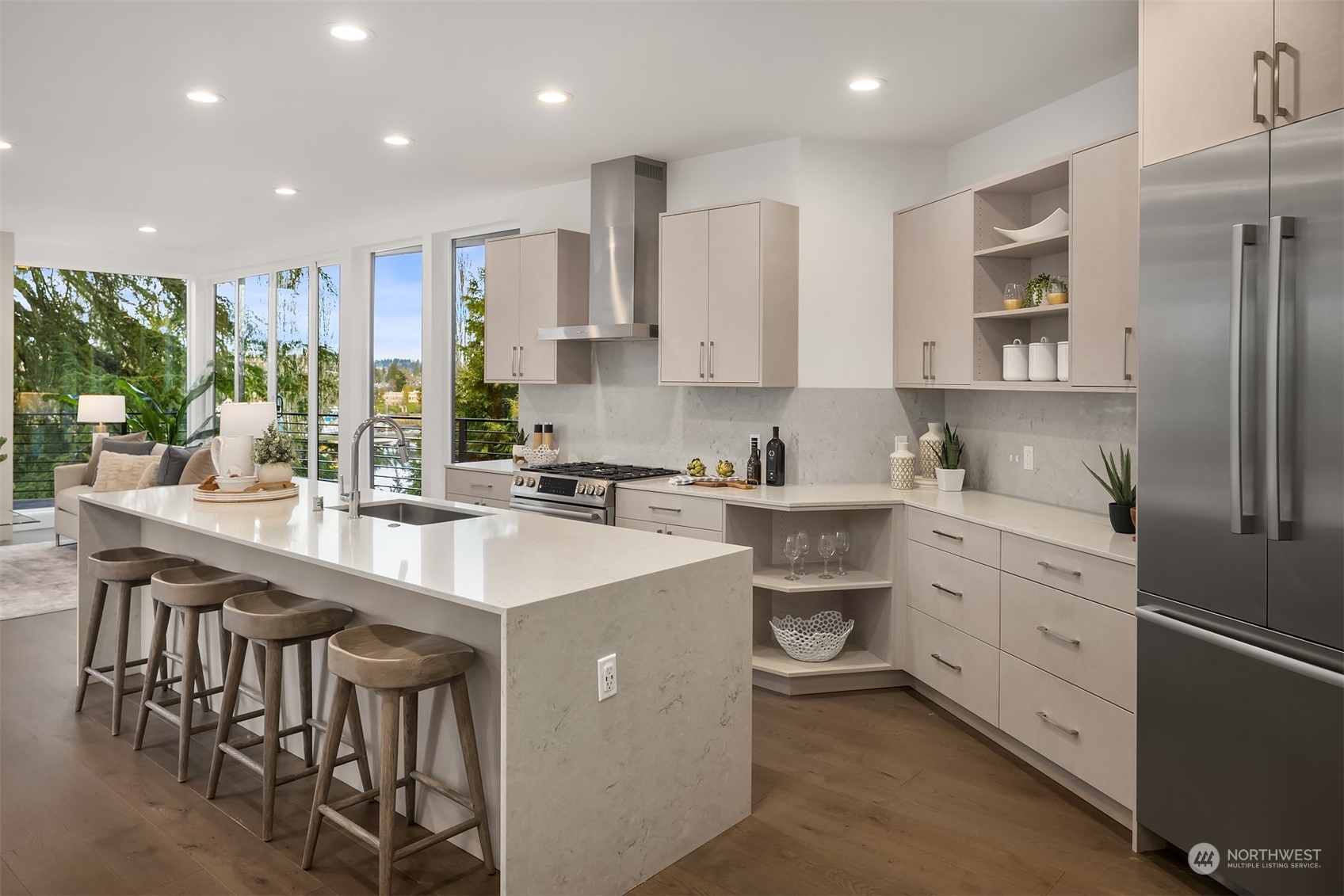 Gourmet chef's kitchen with Bosch stainless steel appliance package, modern waterfall kitchen island with seating.