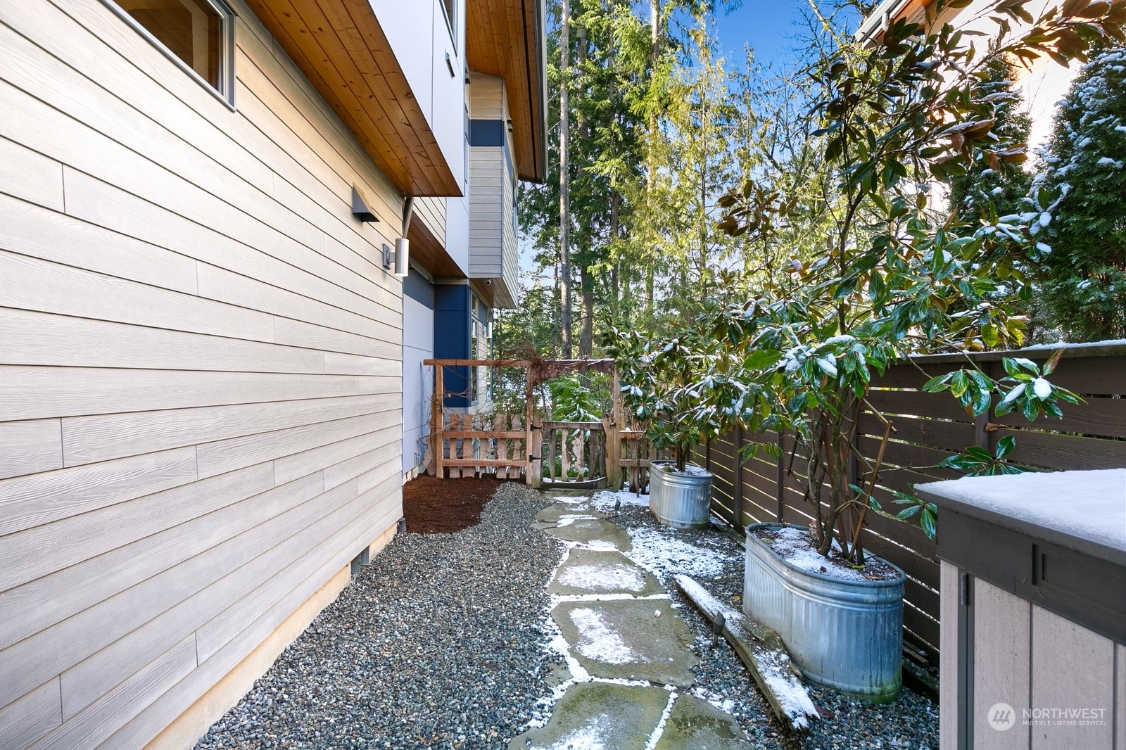 Three separate sections outside, all fully fenced. This may be a perfect dog run, with a storage shed and access to the garage as well. Pretty dwarf magnolia trees as a bonus