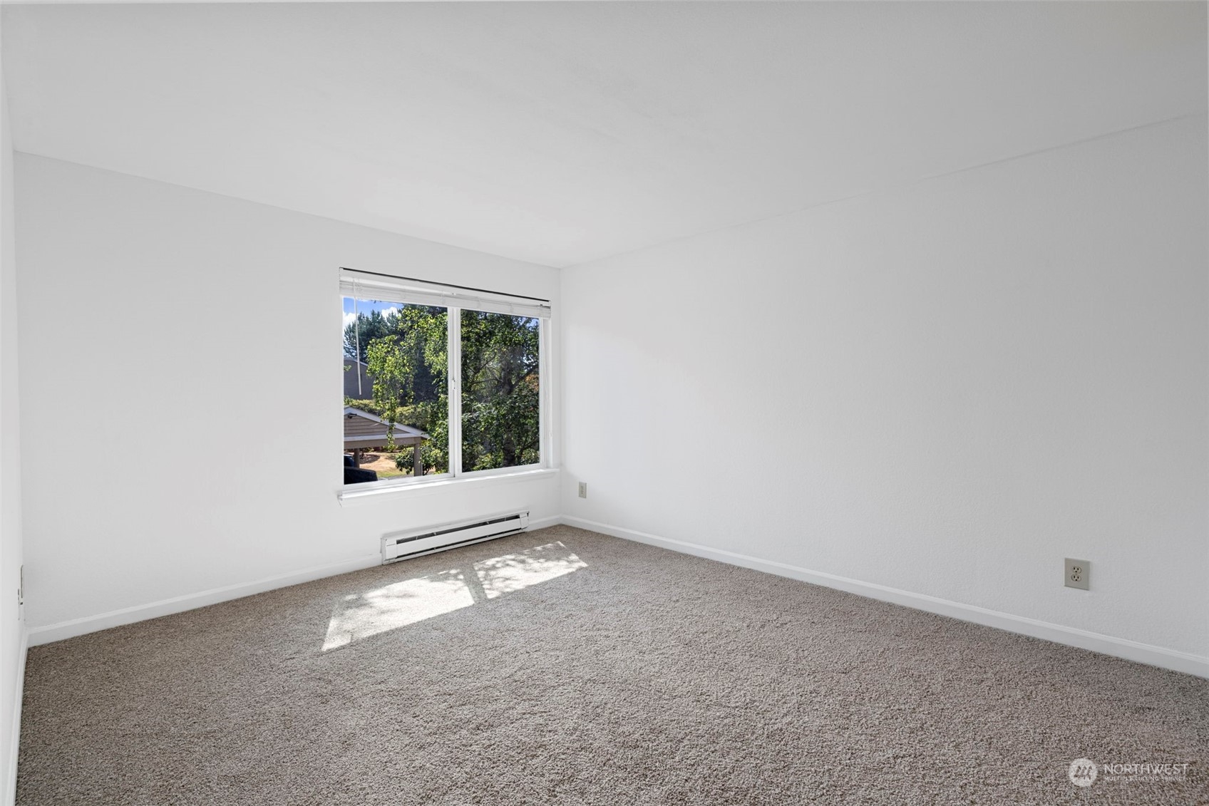 Spacious primary bedroom featuring two closets and a private vanity with a sink for added convenience.