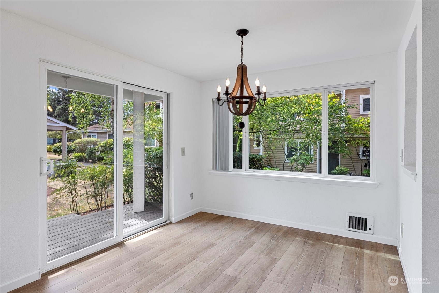 The dining area provides plenty of room for a full-sized table, making it ideal for shared meals or entertaining, with easy access to the kitchen for seamless hosting.