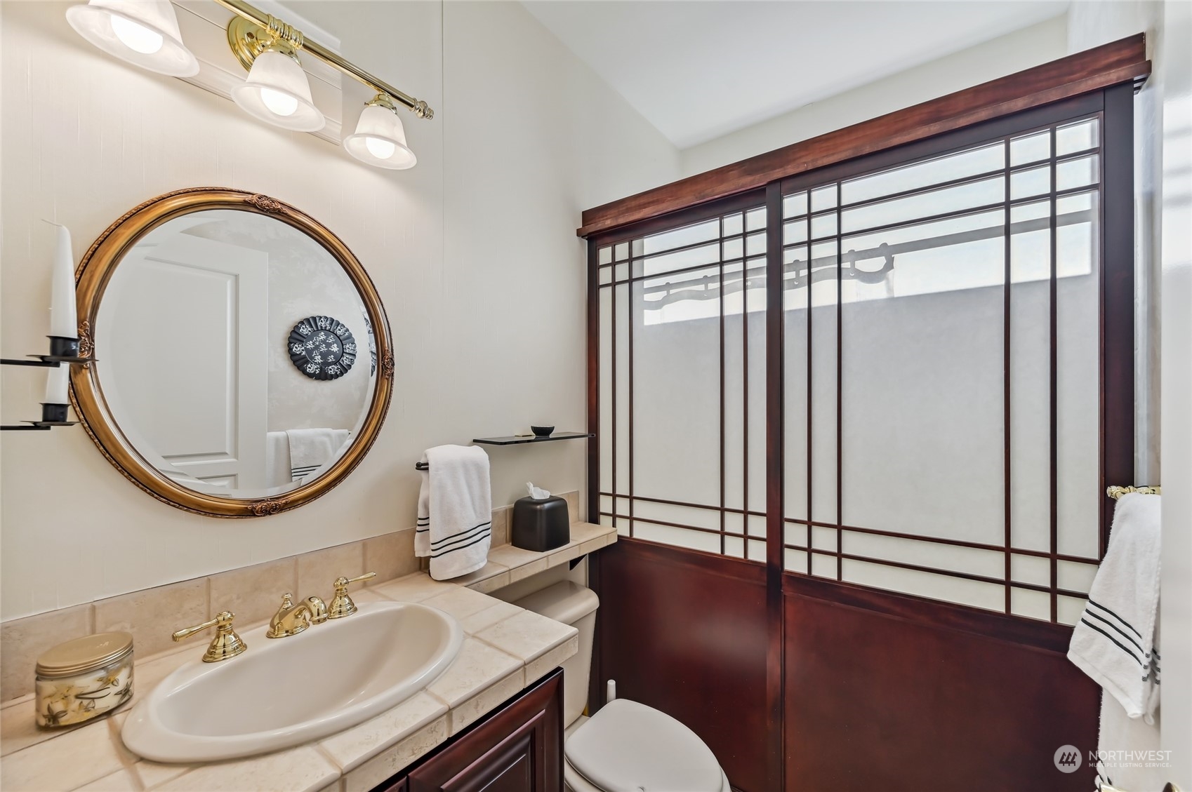 The main bathroom has a custom sojii screen instead of a shower door.