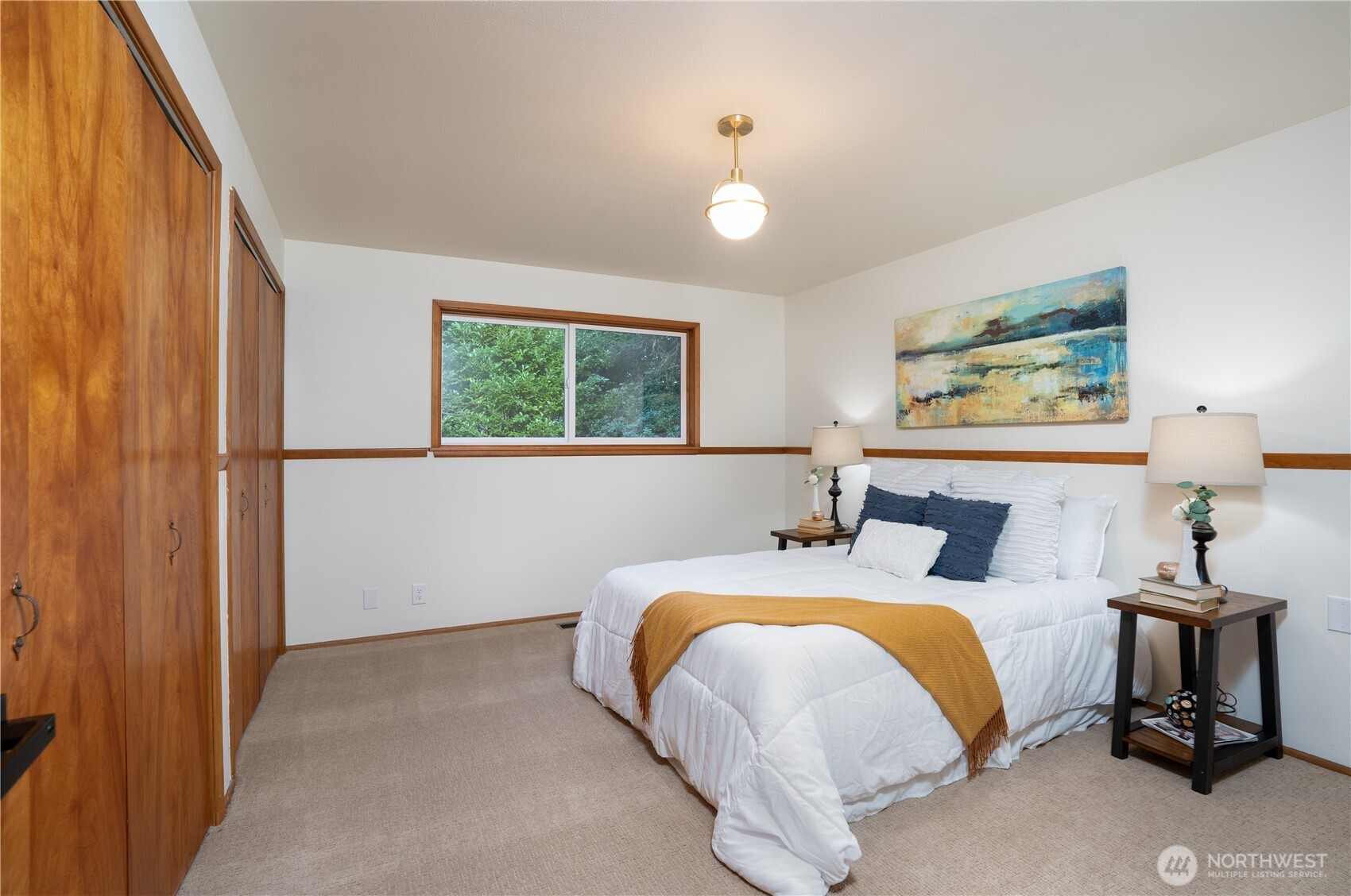 Primary bedroom with dual closets, located next to main bathroom.