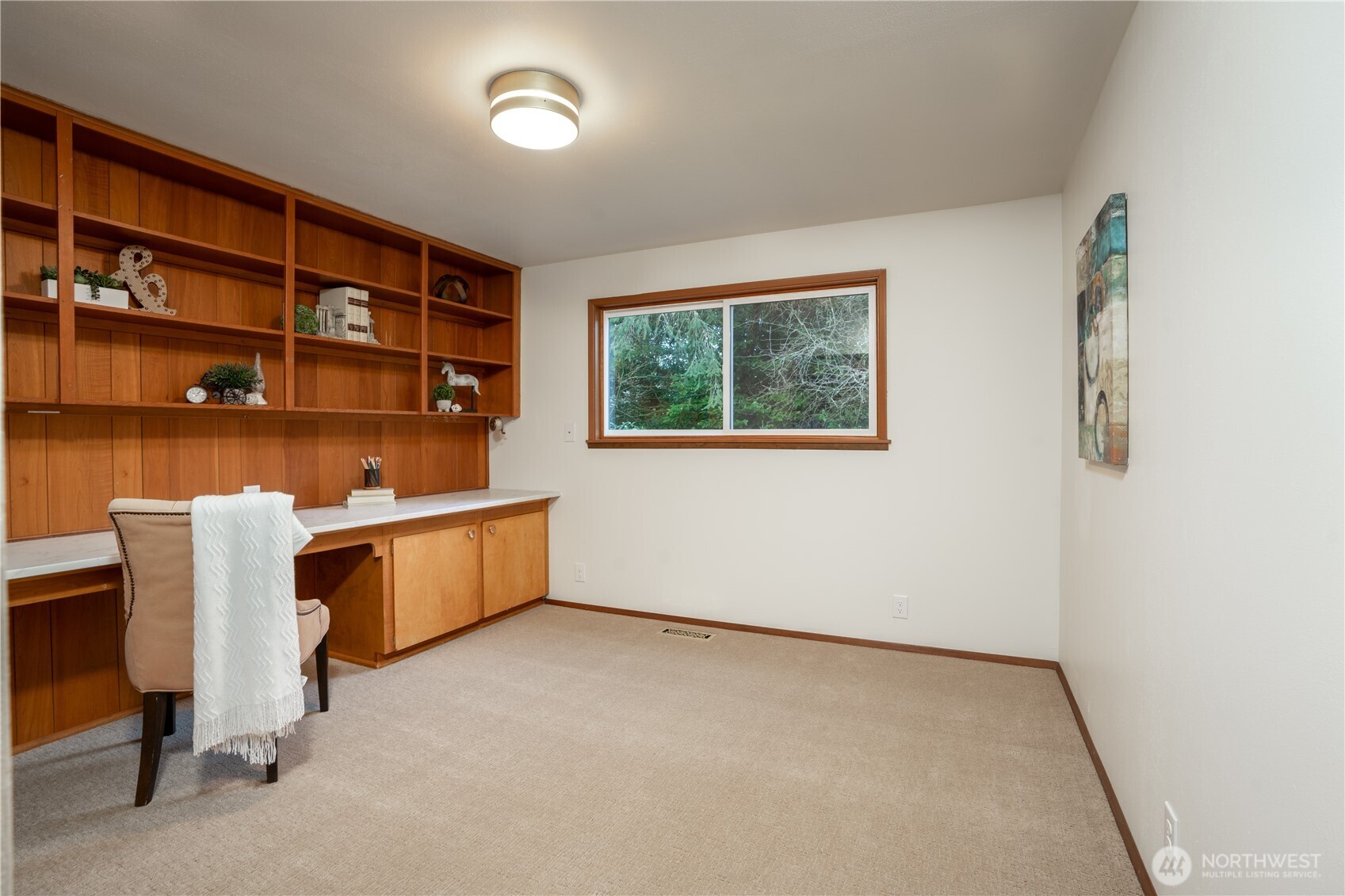 Bedroom #2 second of two bedrooms on main floor, complete with built in desk, base cabinet and shelving. This space would be a great home office for those who like to work from home!