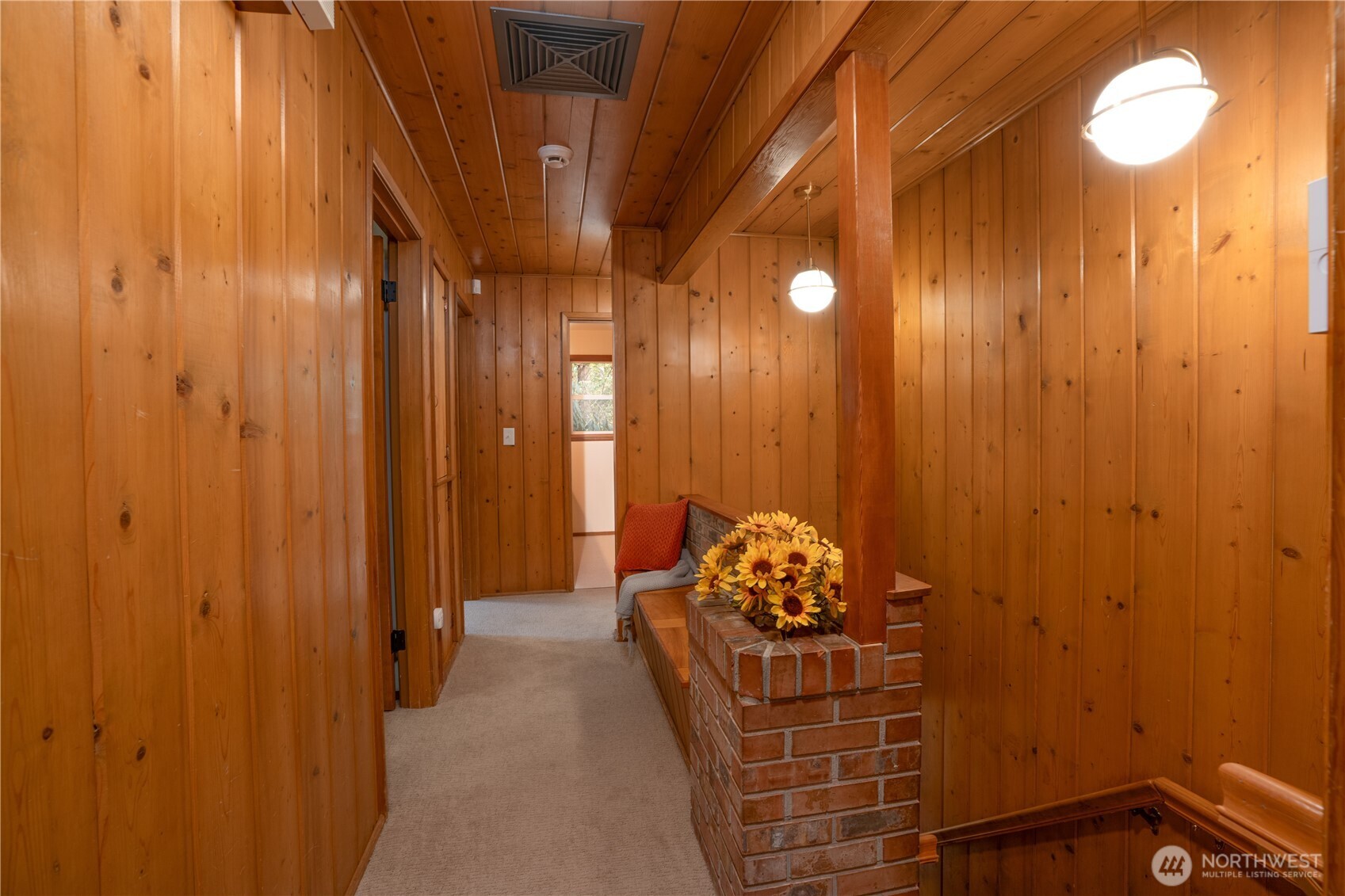 When you step in through the front door you will be welcomed by the warmth of the wood, the sweet brick flower box and bench in this quintessential MCM Lakewood home.