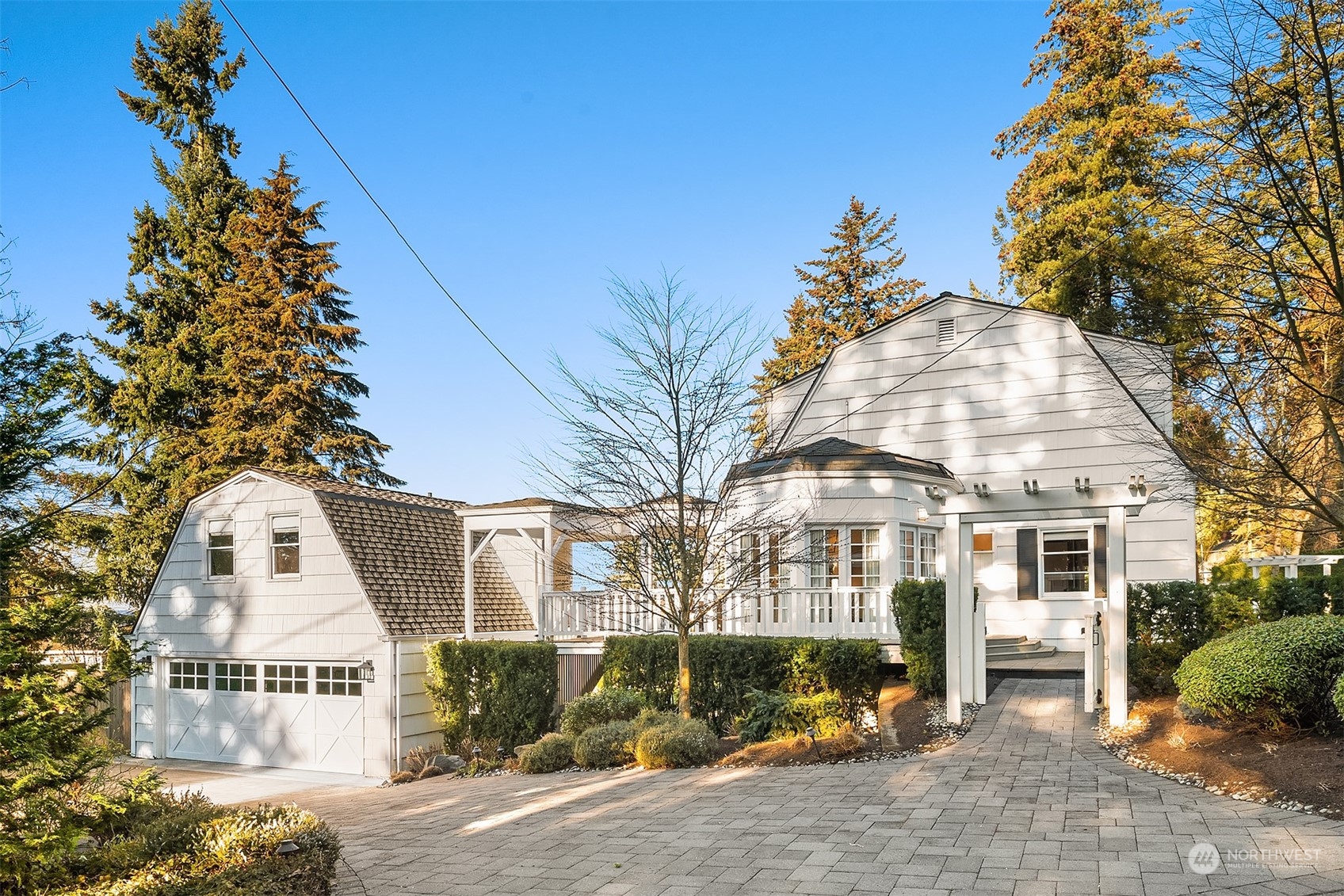 Nestled on an expansive 16,200 sq. ft. west-facing corner lot in Clyde Hill, this stunning Dutch Colonial blends traditional charm with modern sophistication