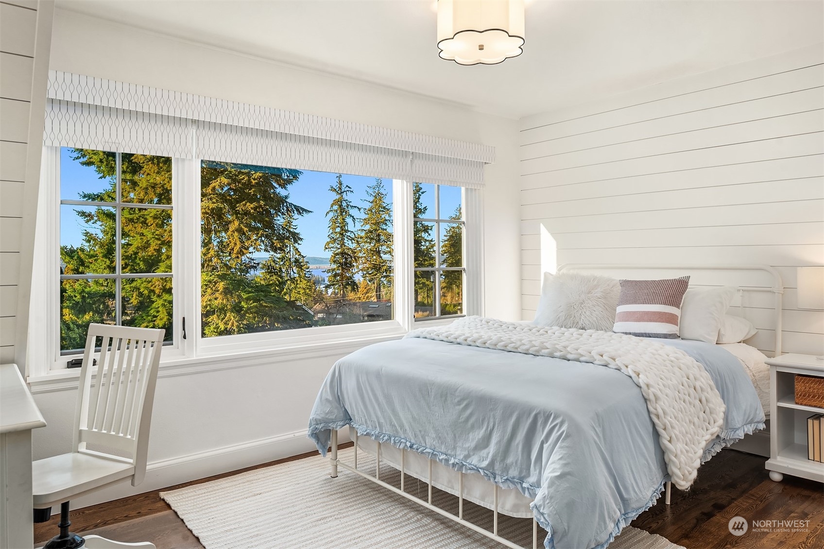 One of two additional upper level bedrooms - all featuring hardwood flooring.  All rooms enjoy Westerly Lake and mountain views + this room has the sweetest shiplap accent walls.