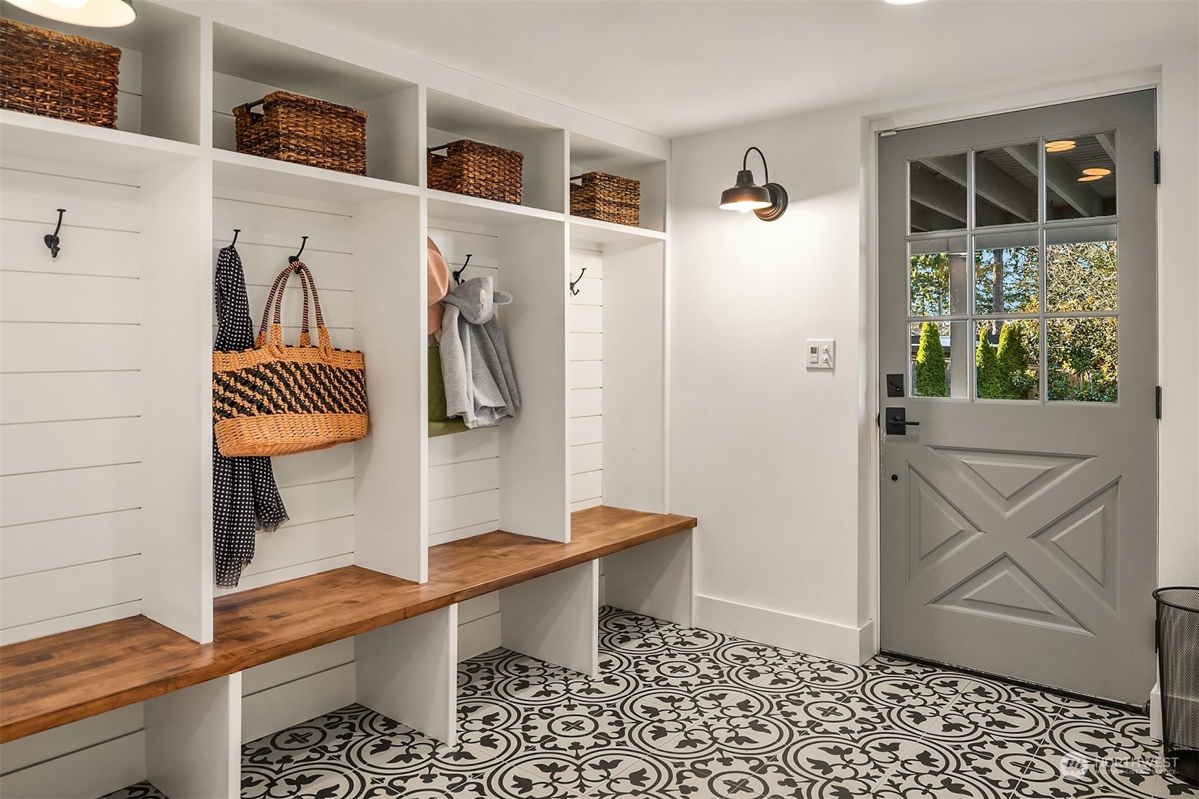 Perhaps the cutest mudroom I have ever seen, featuring 4 cubbies w/benches, cement tile flooring, custom light fixtures and a door to access the back yard.